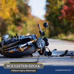 Following a motorcycle accident in Warsaw, a damaged motorcycle lying in the road with debris