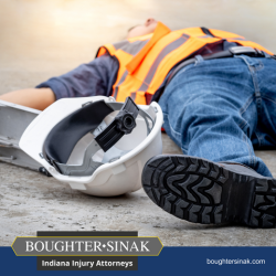 A construction worker lies on the ground injured after a fall on a jobsite in Warsaw